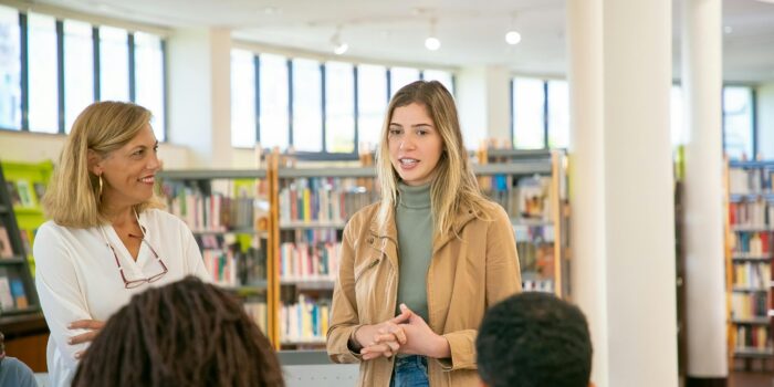 A group of people having a conversation in a library